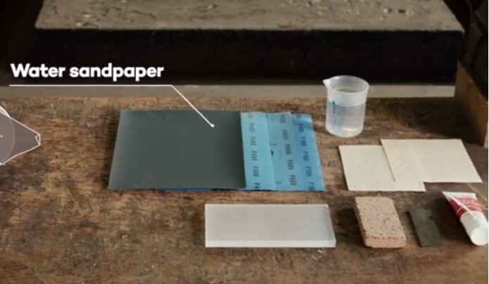 What type of sandpaper should be used to sand acrylic plastic
