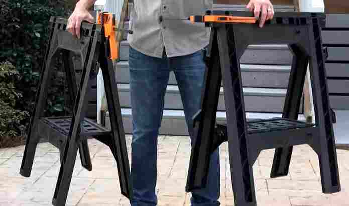 When is it appropriate to use clamps to secure wood to a sawhorse